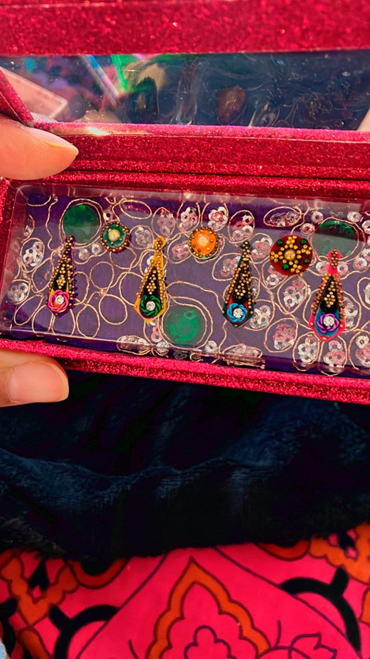 Handmade colorful marigold Jungle Bindis or nail art with gold beads and velvet face and body stickers